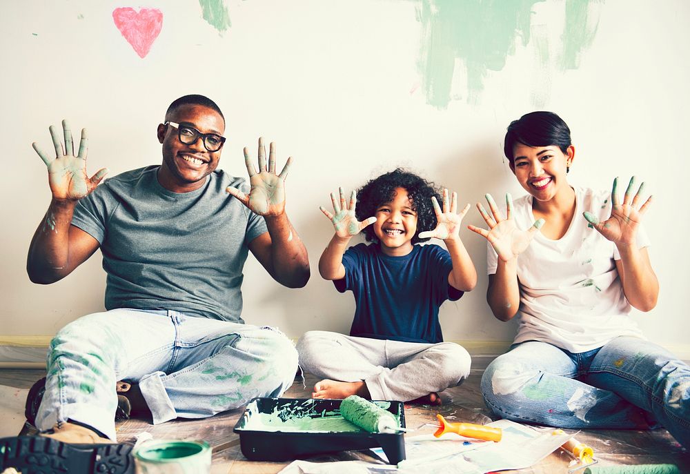 Black family painting the house wall