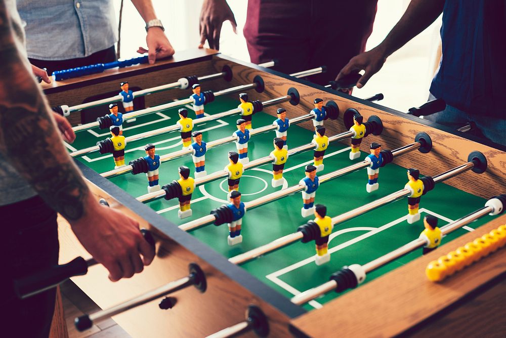 People playing a game of foosball