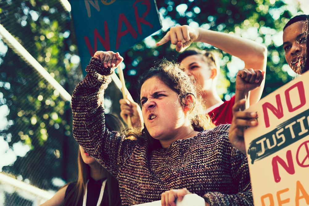 Closeup of angry teen girl protesting against war