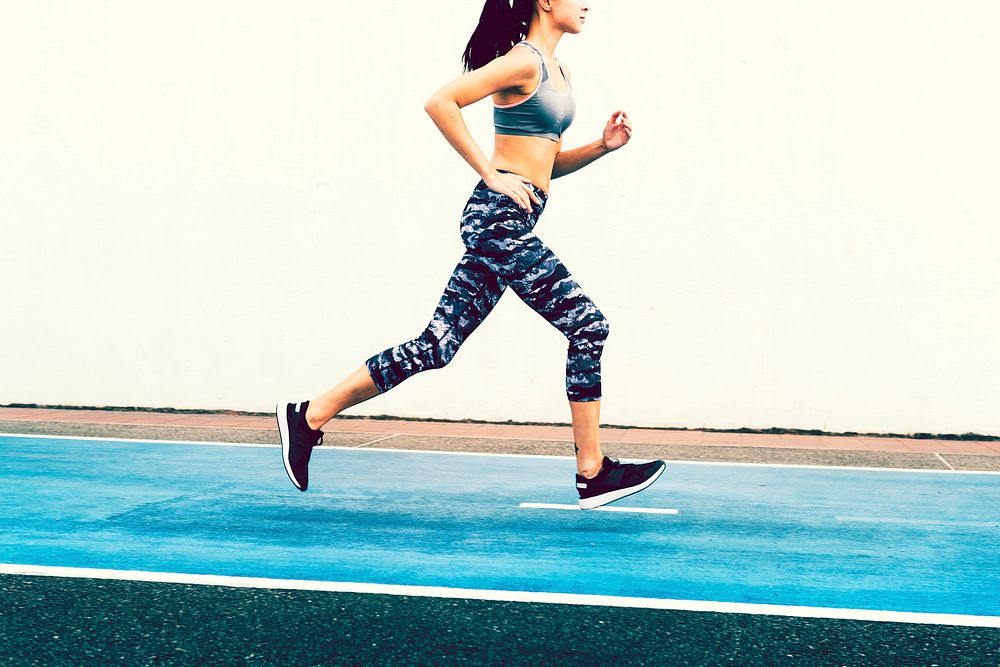 Young woman running on a track