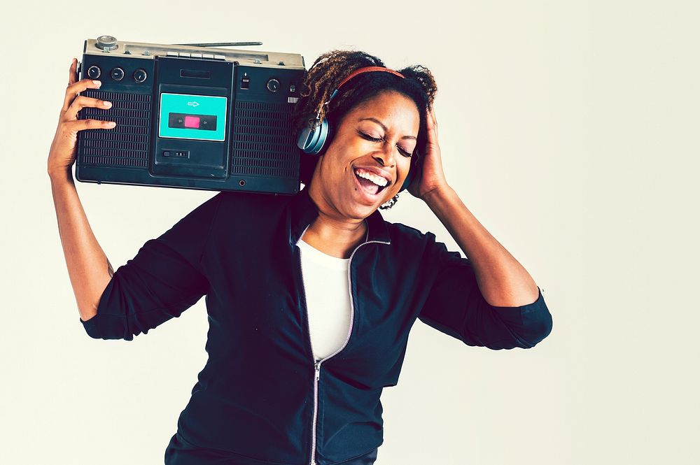 A woman listening to music from a radio