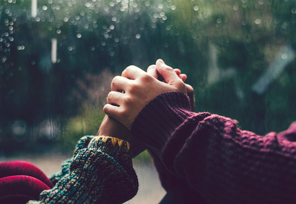 Happy couple holding hands in the rain