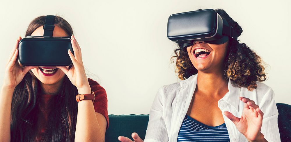 Women experiencing virtual reality with goggles