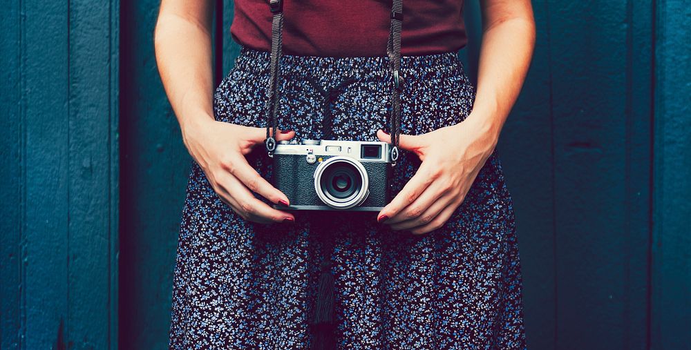 Woman holding an analog camera