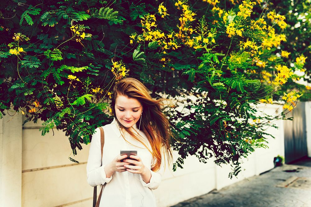 Young woman playing on her phone