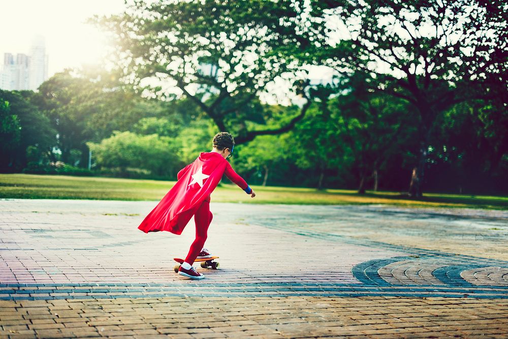 Superhero boy on a skateboard