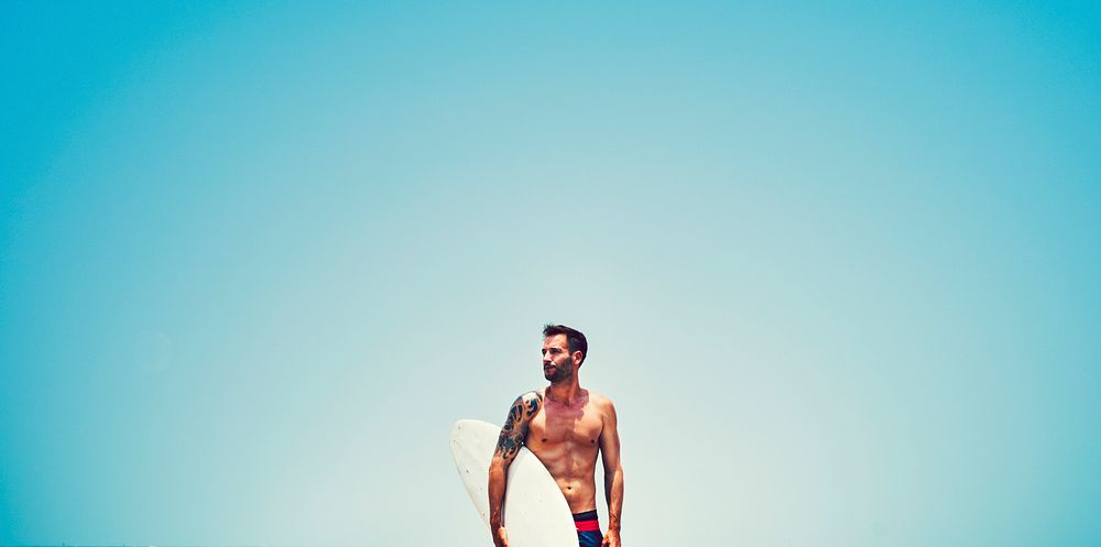 Handsome surfer at the beach