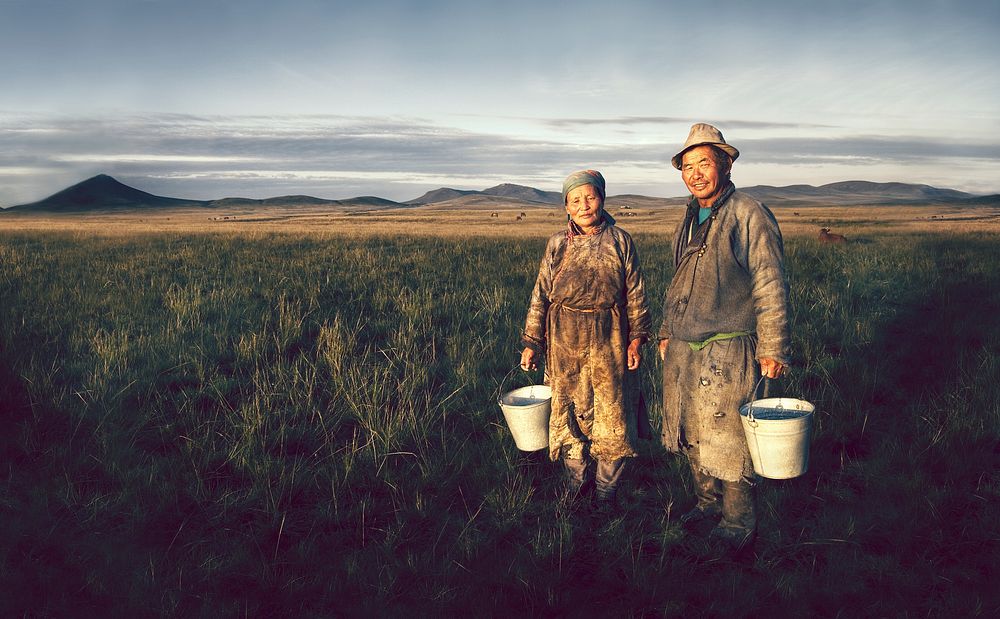 Mongolian farmers holding basin in the field