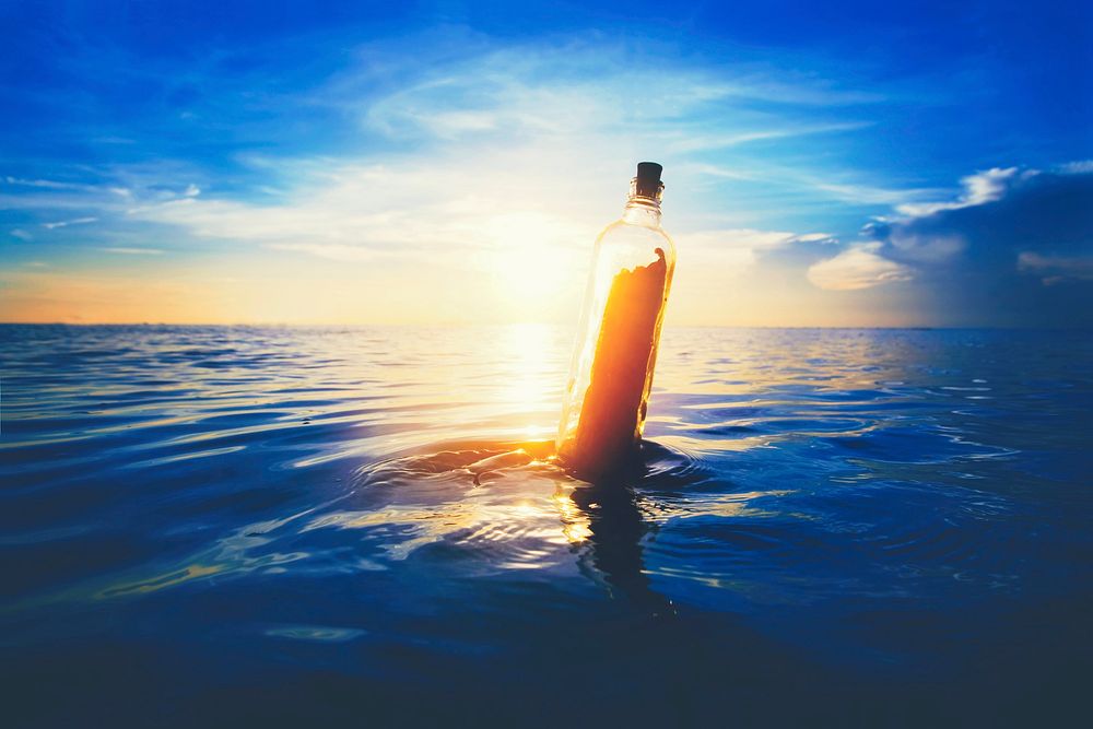 Message in a bottle floating at sea