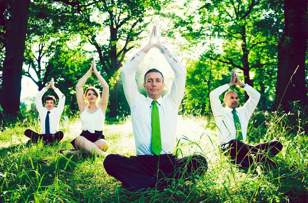 Business people doing yoga outdoors