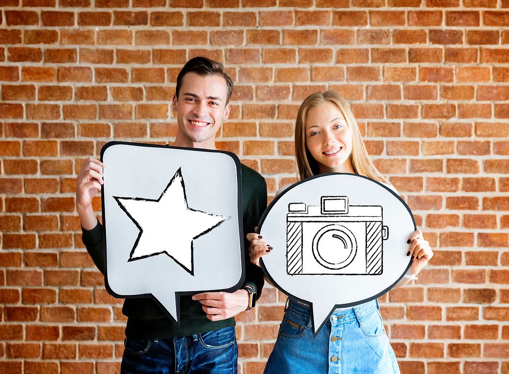 Young couple holding social media icons