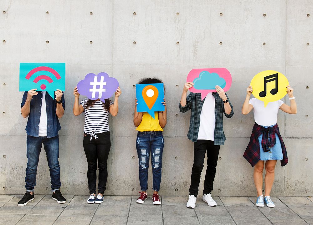 Teenagers covering their faces with social media icons