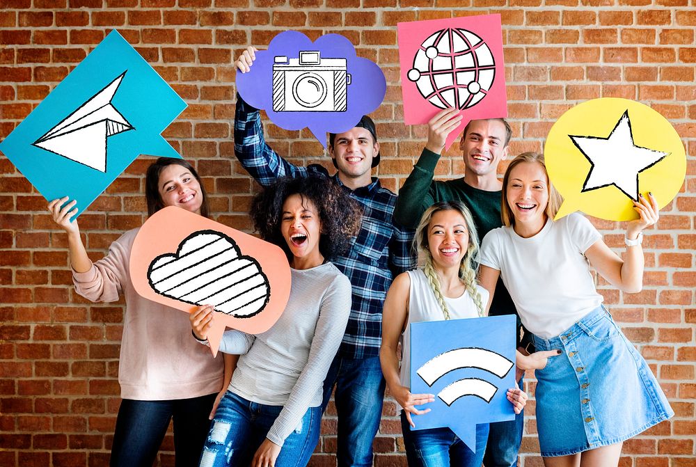 Cheerful friends holding social media icons