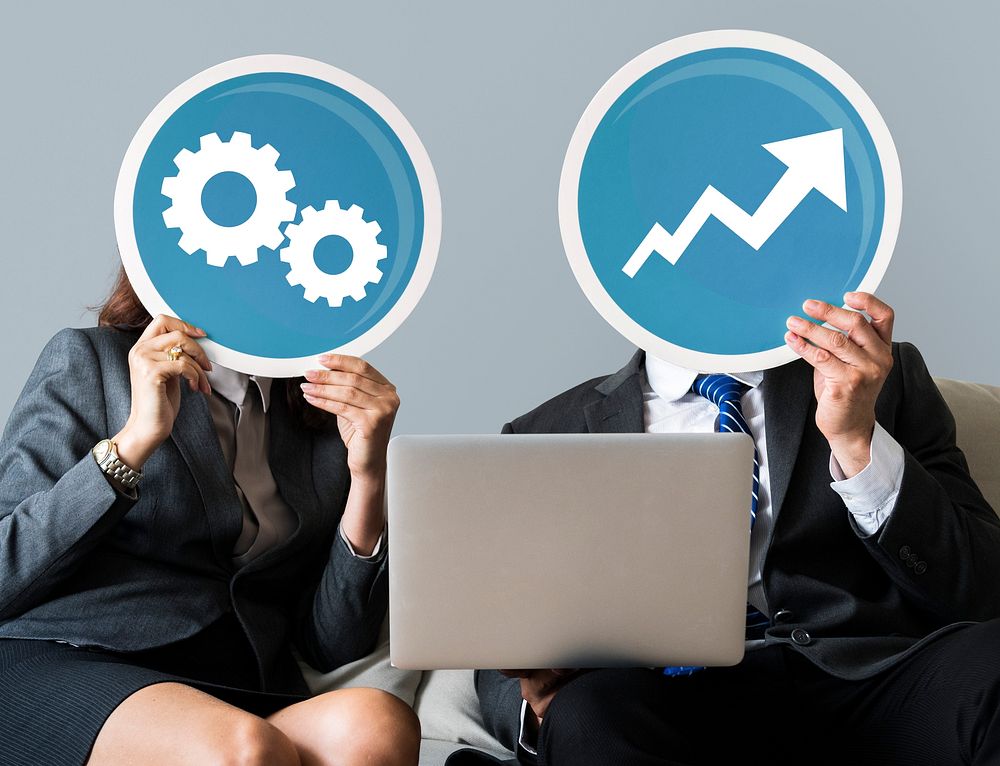 Business people holding gear and growth icons