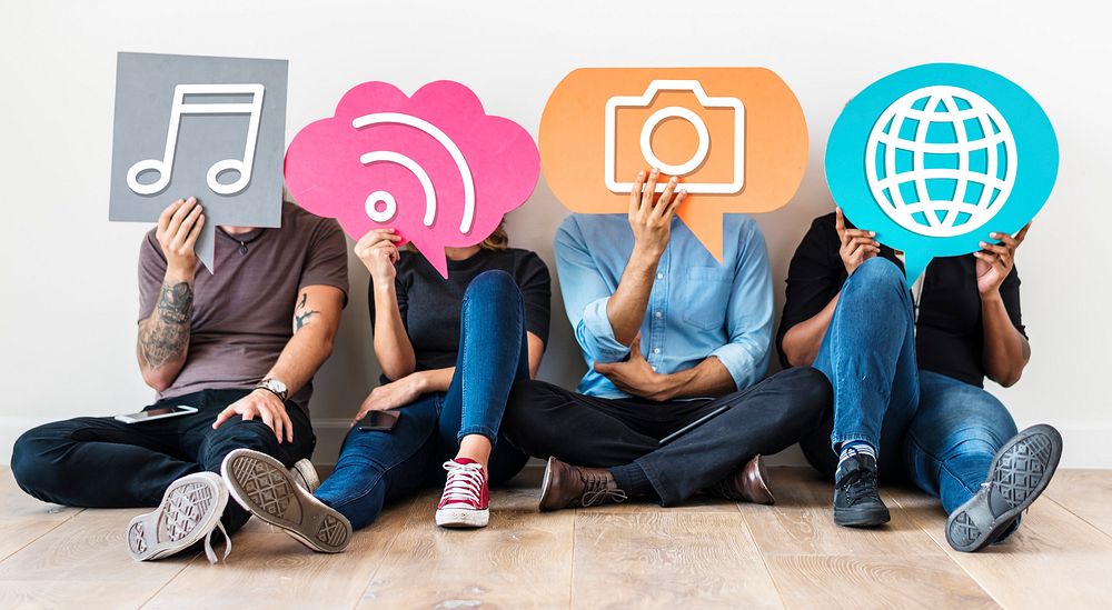 Diverse friends holding social media icons