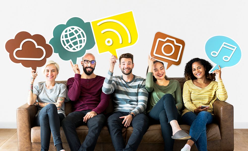 Cheerful people holding social media icons