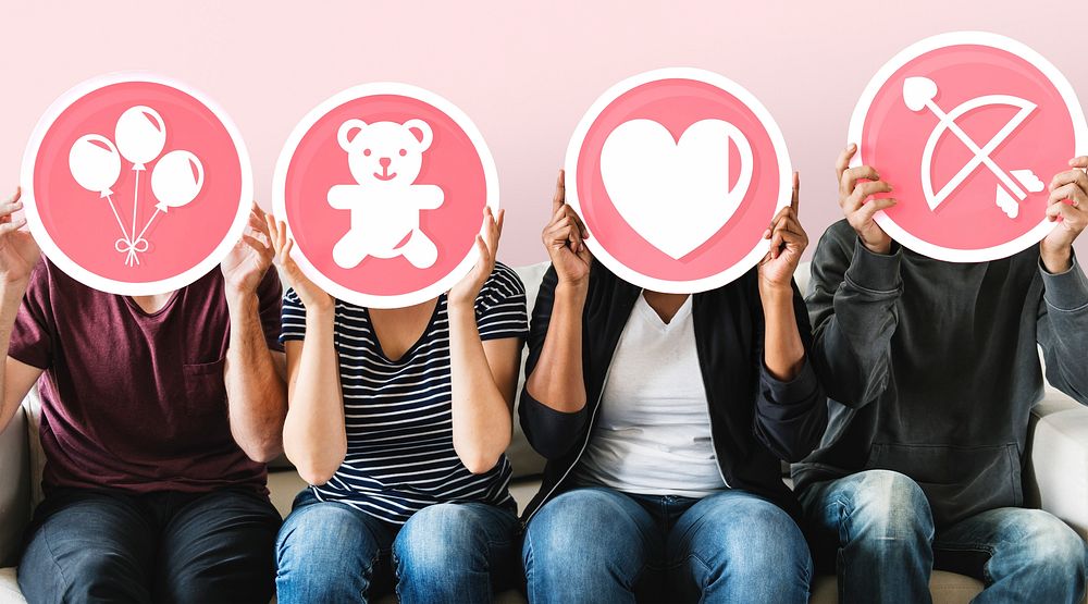 Diverse people holding valentine icons