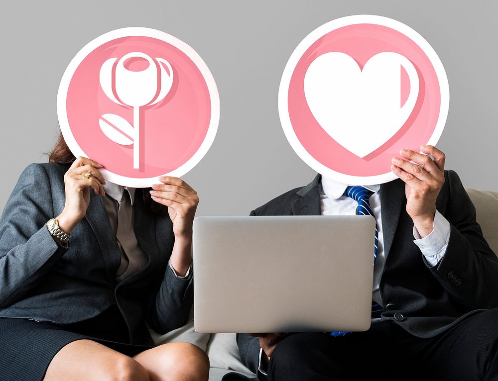 Business couple holding heart icons
