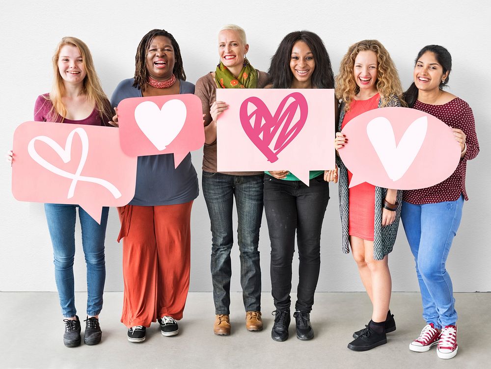 Group of women holding heart icons