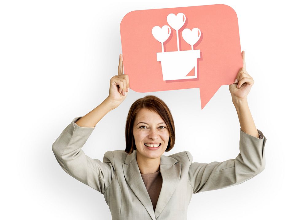 Businesswoman holding speech bubble with heart icon