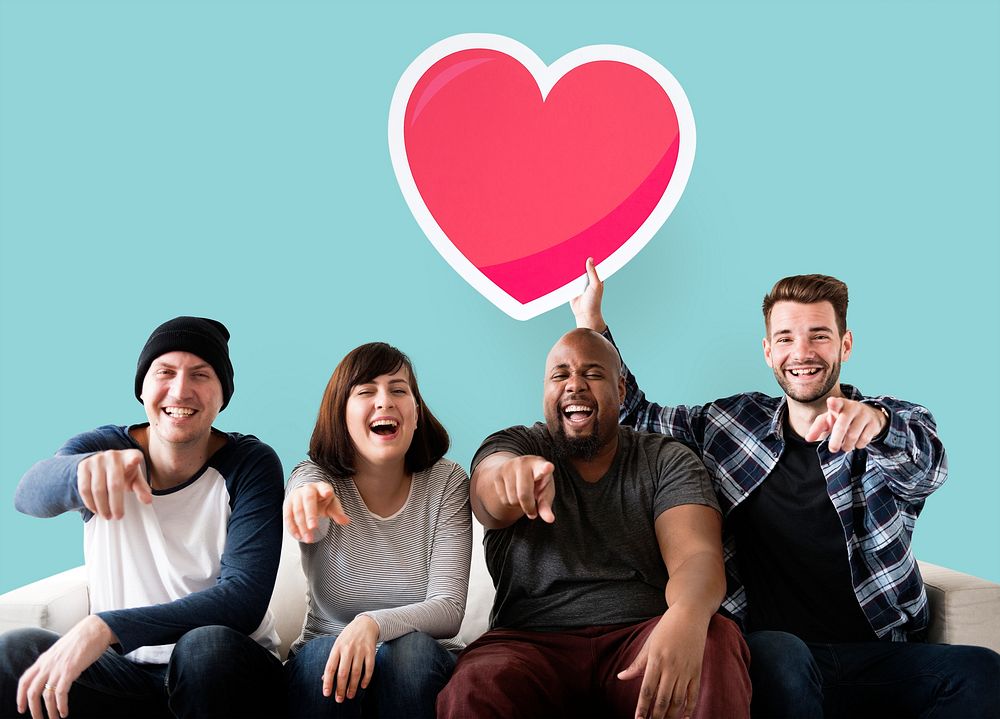 Group of happy friends holding a heart emoticon