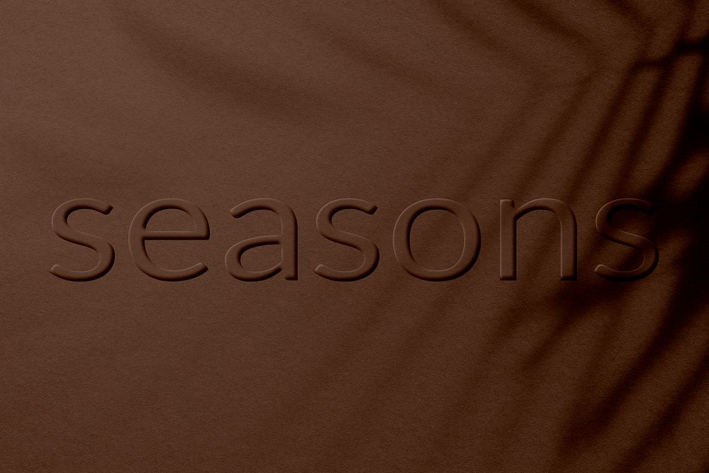 Seasons word embossed concrete colored texture