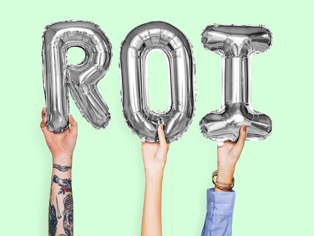 Hands holding ROI word in balloon letters