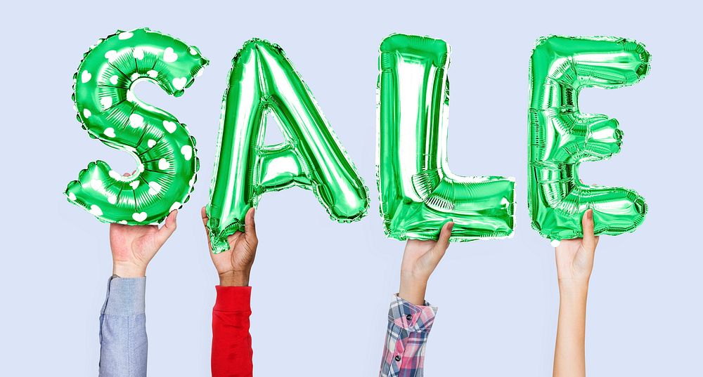 Hands holding sale word in balloon letters