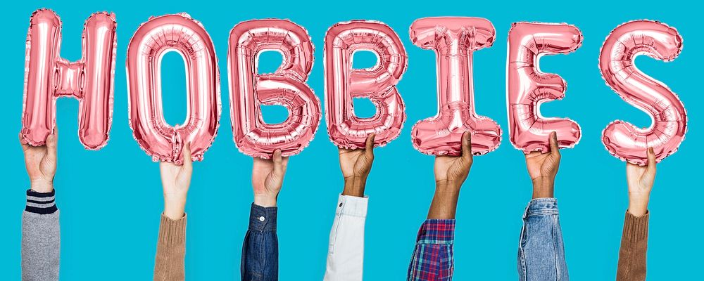 Hands holding hobbies word in balloon letters