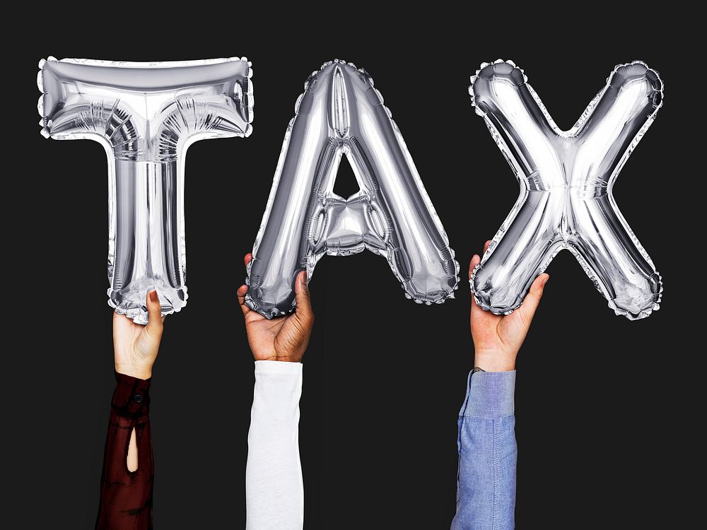 Hands showing tax balloons word