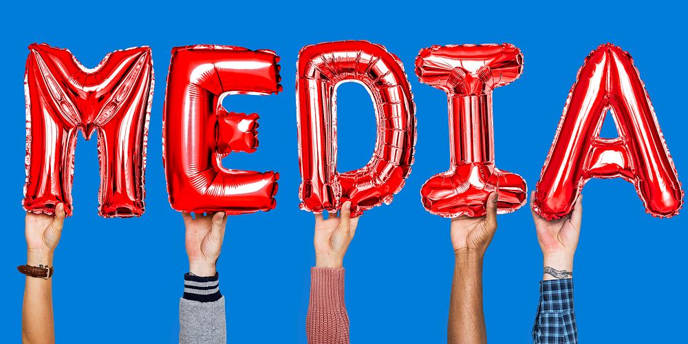 Red alphabet helium balloons forming the text media