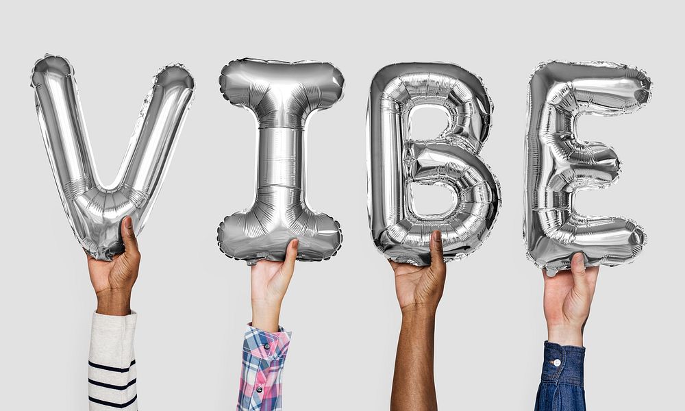 Gray silver alphabet balloons forming the word vibe
