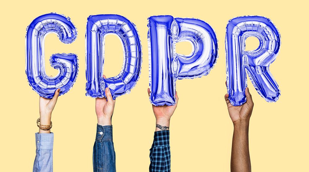 Hands holding GDPR word in balloon letters