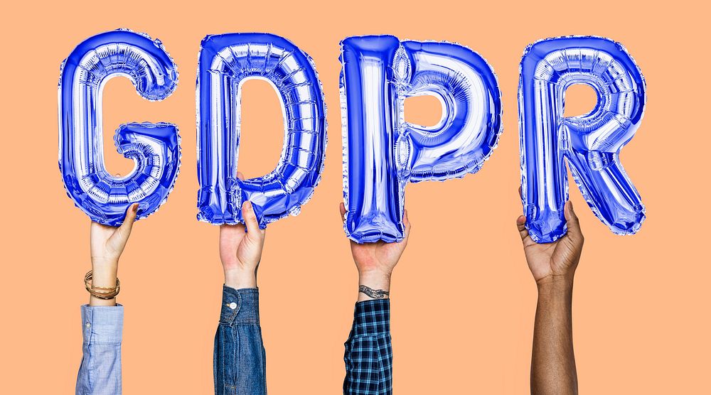 Hands holding GDPR word in balloon letters