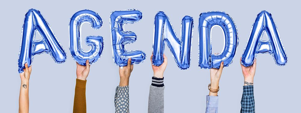 Hands holding agenda word in balloon letters