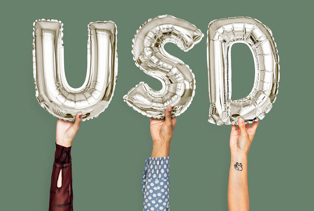 Hands holding USD word in balloon letters