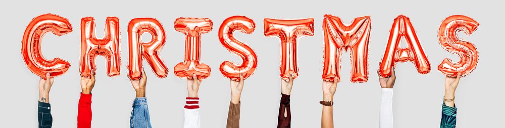 Hands holding balloons spelling Christmas