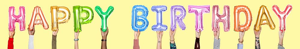 Hands holding Happy Birthday word in balloon letters