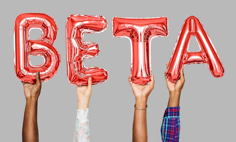 Hands holding beta word in balloon letters