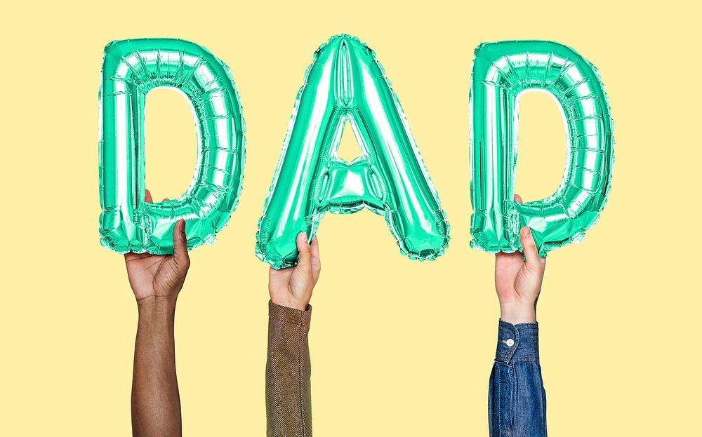 Hands holding dad word in balloon letters