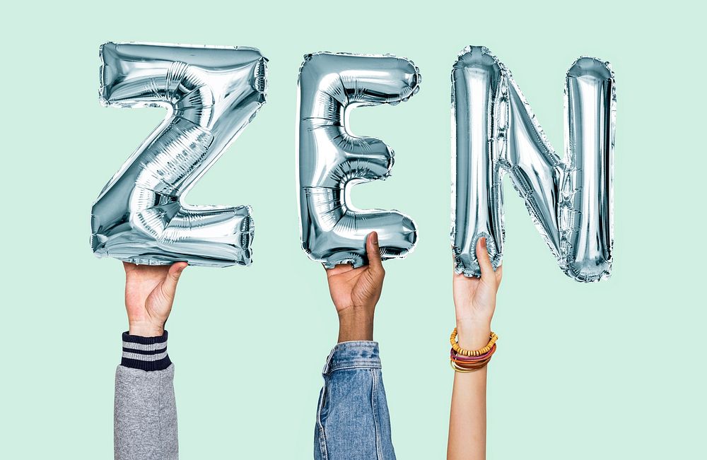 Hands holding zen word in balloon letters