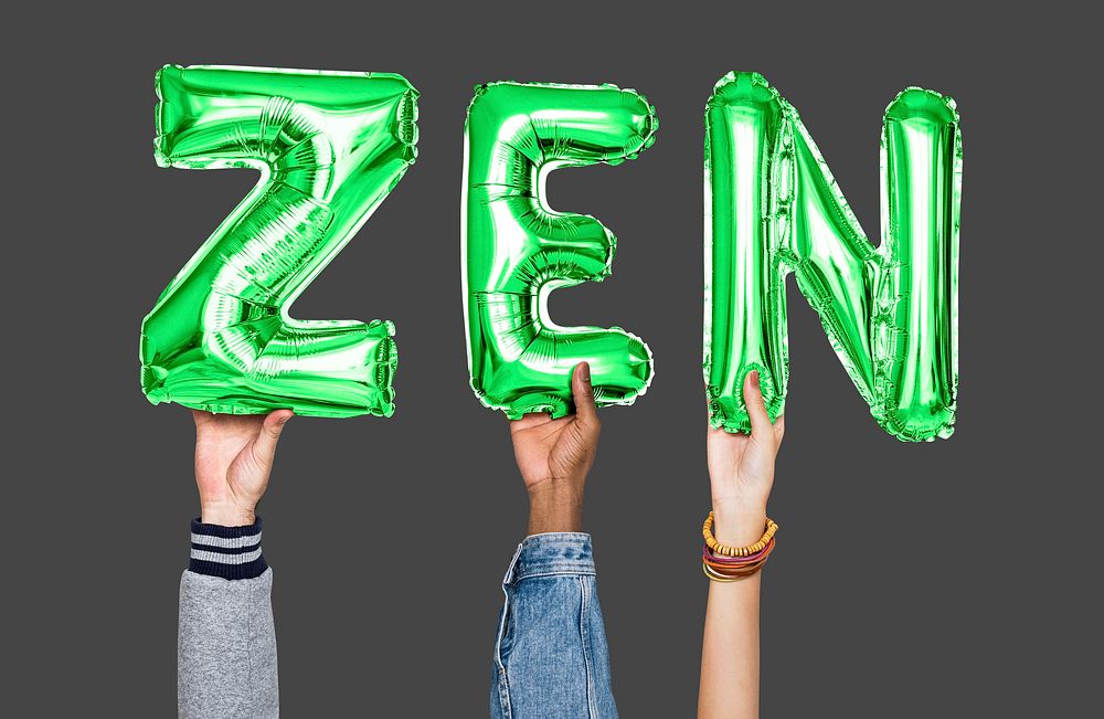 Hands holding zen word in balloon letters