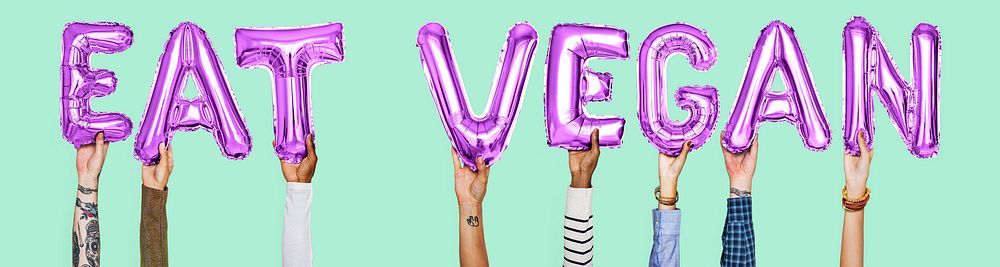 Hands holding Eat Vegan word in balloon letters