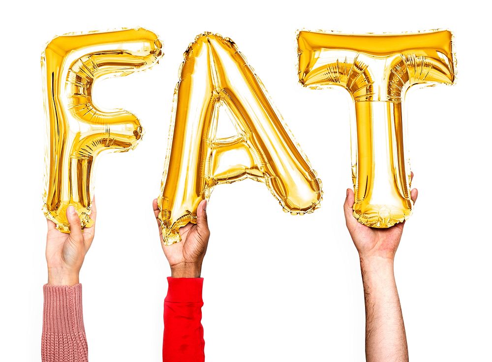 Hands holding balloons spelling Fat
