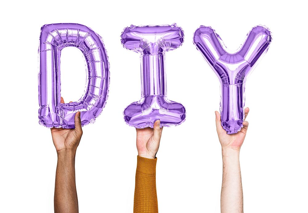Hands holding balloons spelling DIY