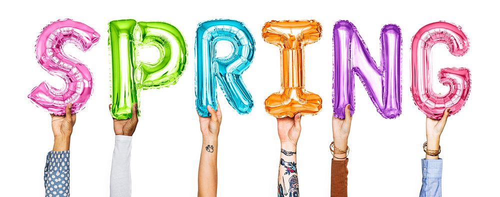 Hands holding balloons spelling the word Spring