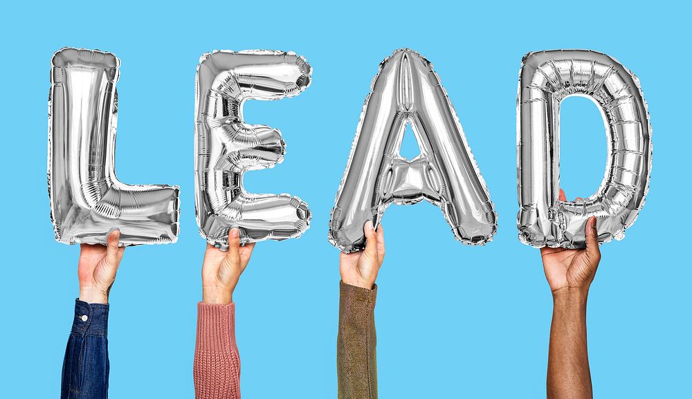 Gray balloon letters forming the word lead