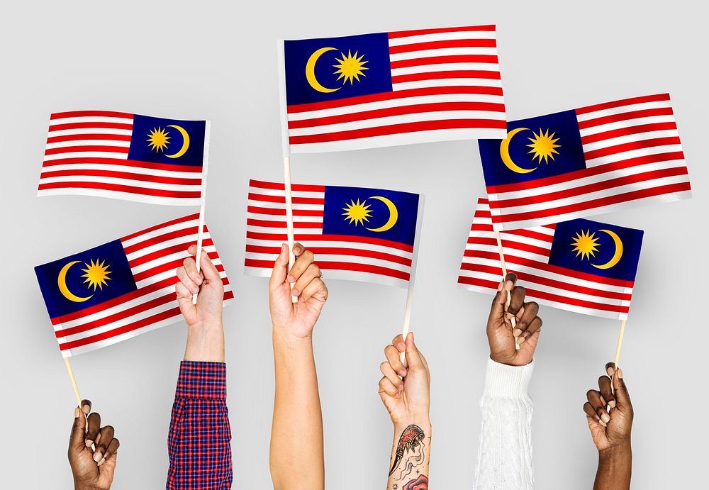 Hands waving flags of Malaysia
