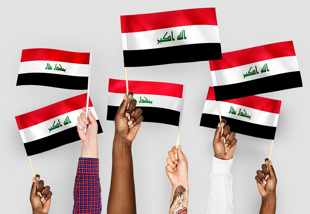 Hands waving flags of Iraq
