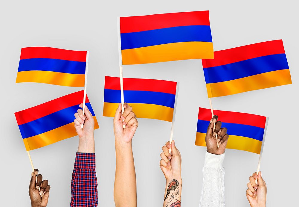 Hands waving flags of Armenia